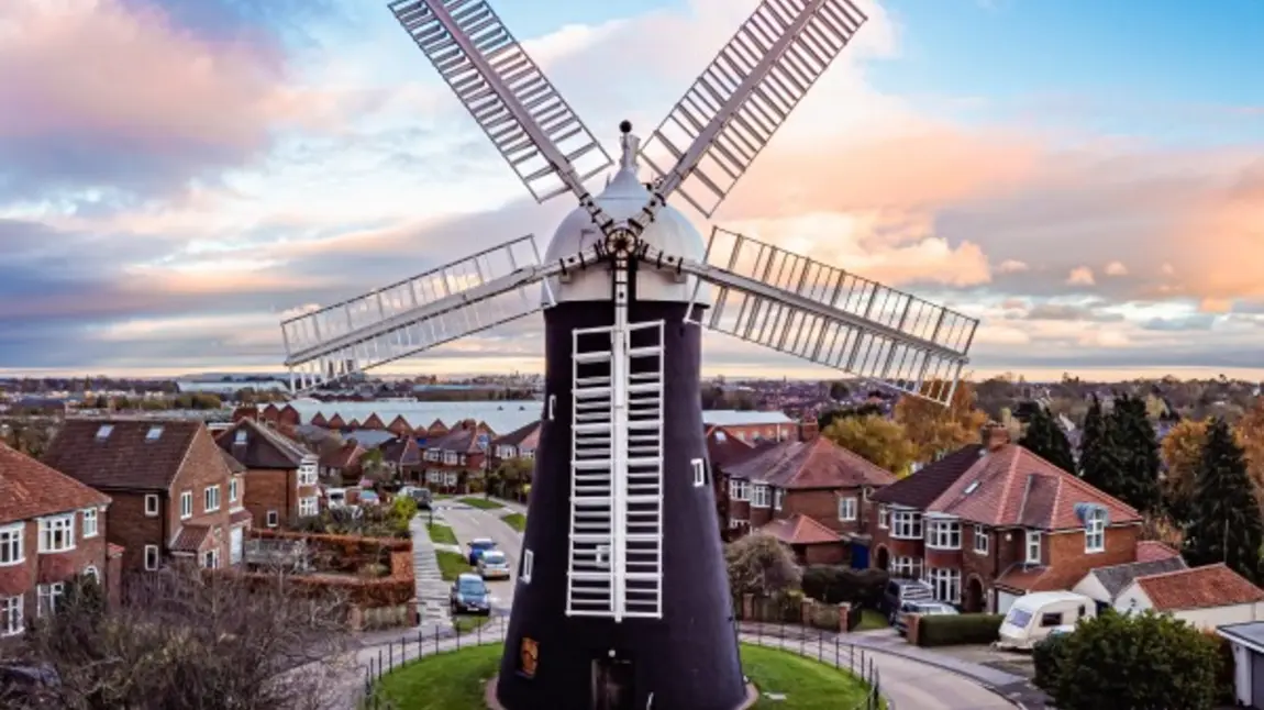 holgate_windmill_york-600.jpg A windmill with houses in the background set against a blue sky