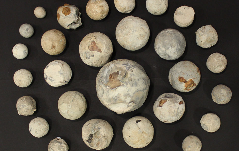 A collection of cannonballs arranged in a circular pattern.