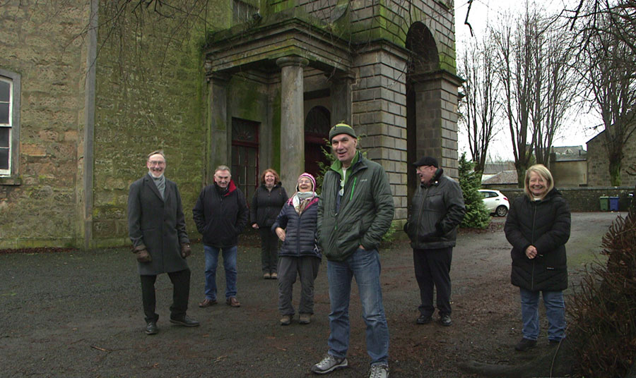 A group of people standing outside a church building