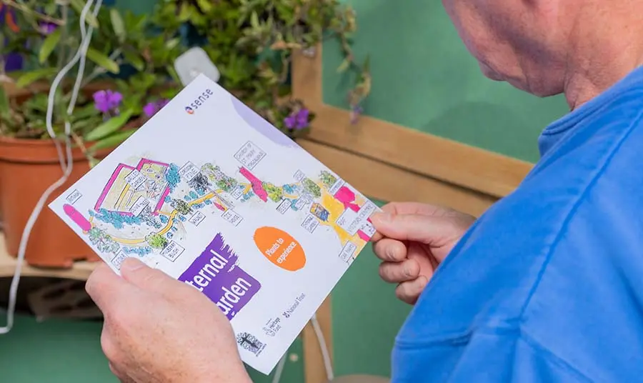 A close up of a person holding an easy read map of Croome.