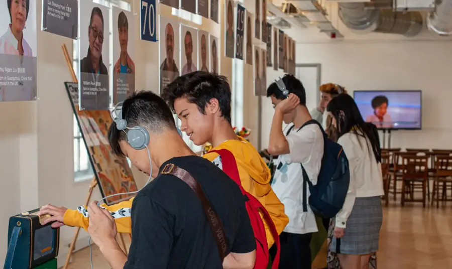 Young people engage in the exhibition and listen to the interviews on a headset