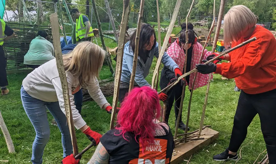 People constructing the timber-framed roundhouse