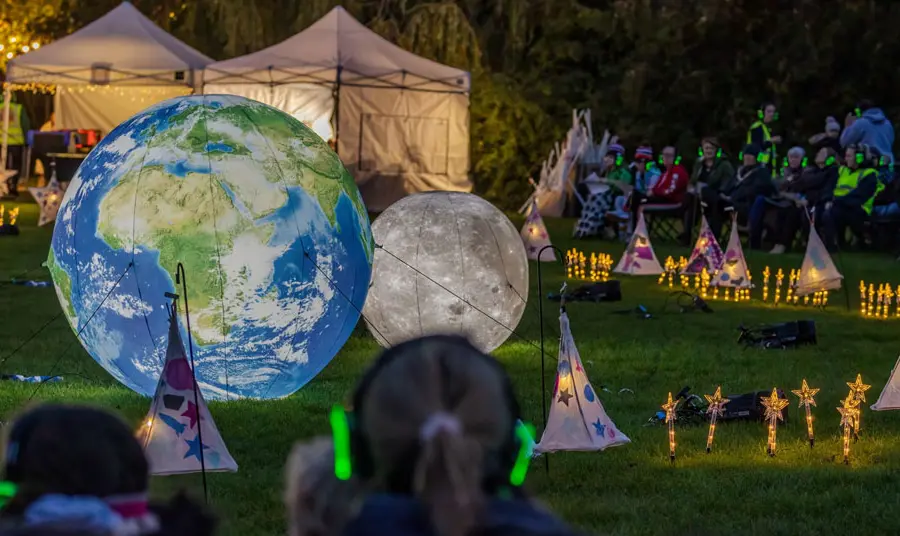 People watching the outdoor planetarium at the Cronton Sun, Moon and Stars event