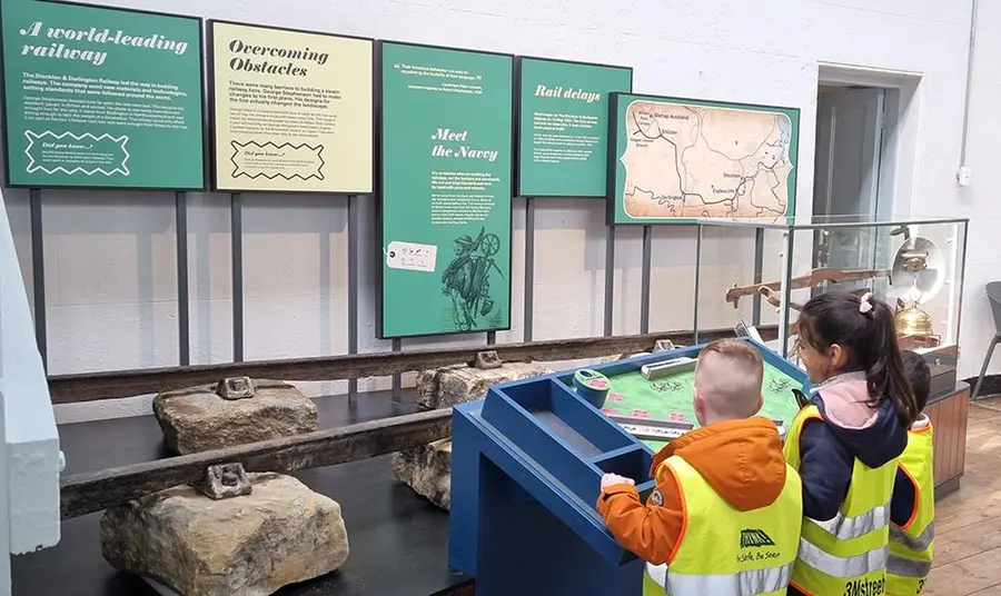 two children look at a display in a museum