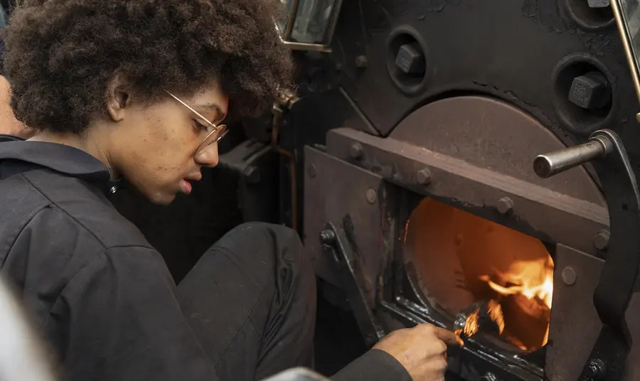 Young person working on a steam train at Blaunau Ffestiniog railway. Credit: Colin McClean