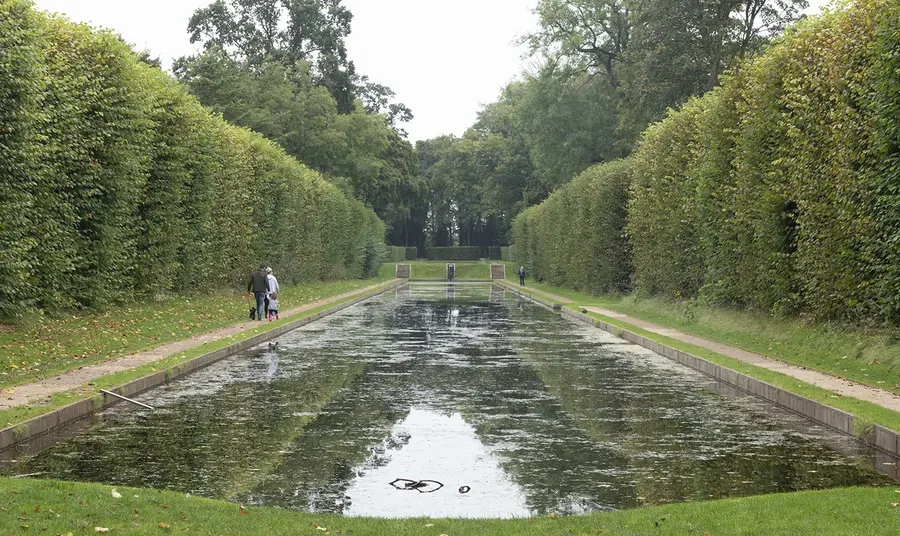 Large pond surrounded by hedges