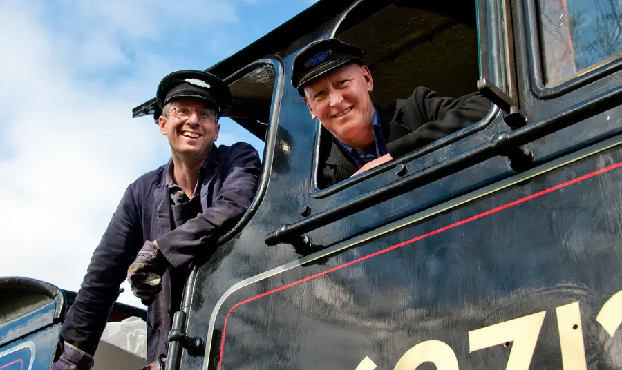 Two men in a steam train