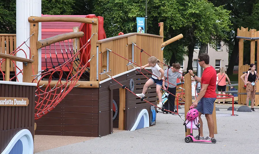 Family playing on playpark structures.