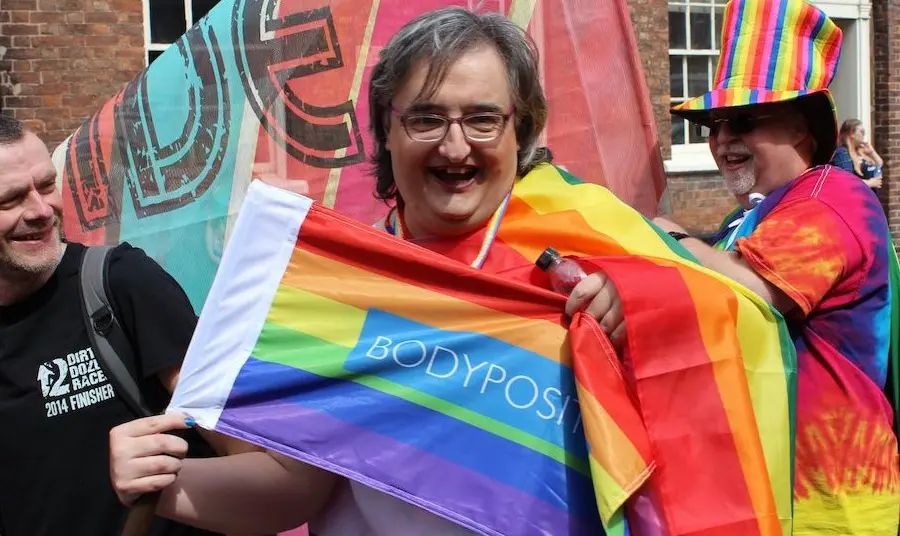 Woman with rainbow flag at Chester Pride