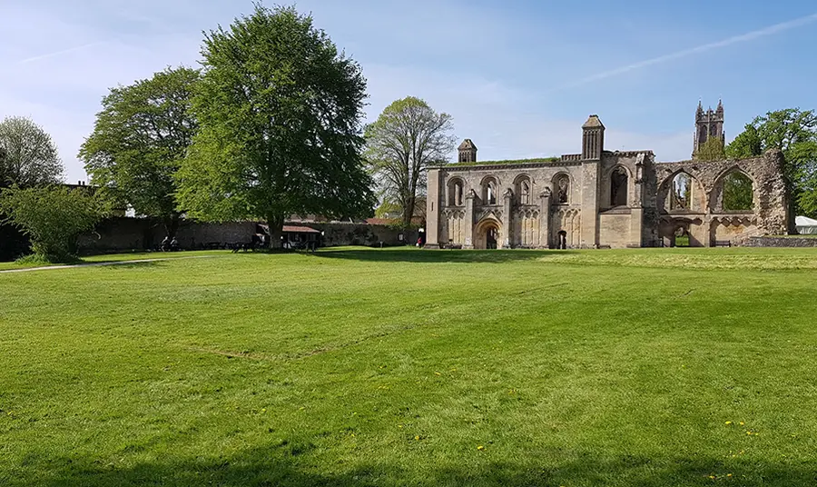 Glastonbury Abbey with a lawn foregrounded