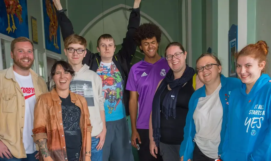 Group of people standing looking at camera