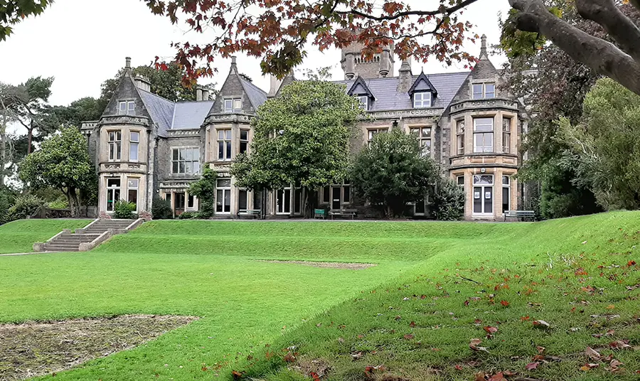 A large mansion with lawn in front