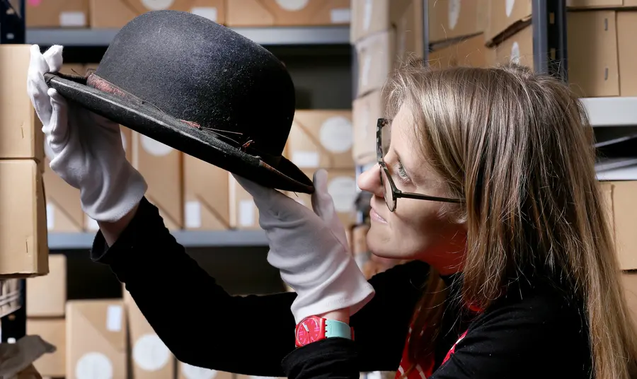 Kerry Vasiliou, Learning and Engagement Manager at the Blackpool Museum Project with Stan Laurel bowler hat