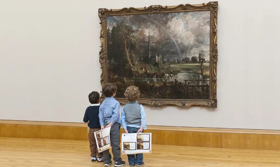 Three children look at Constable painting