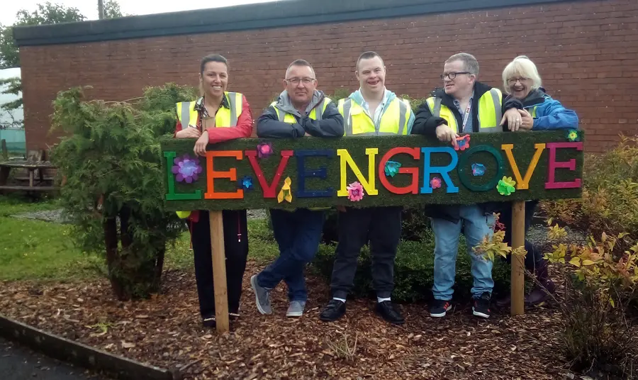 Group stand around park sign