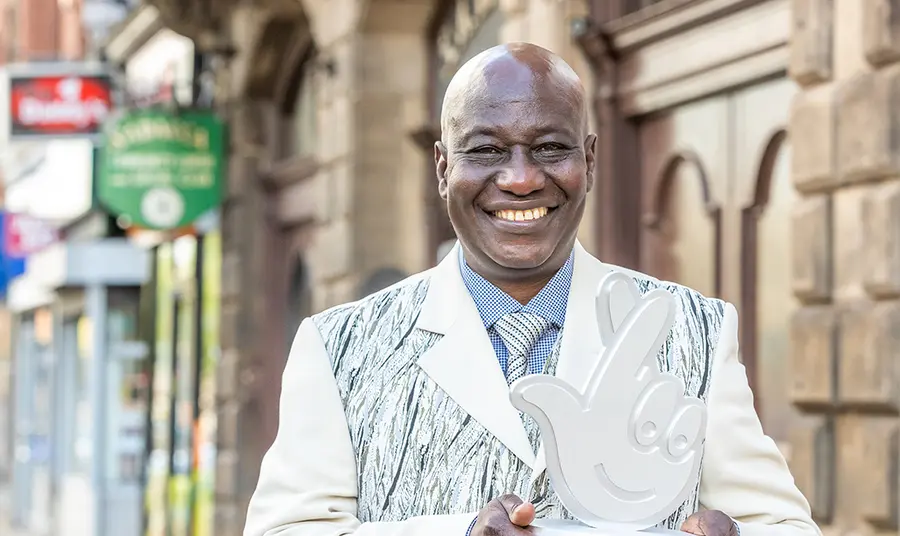 Maxwell Apaladaga Ayamba with lottery trophy