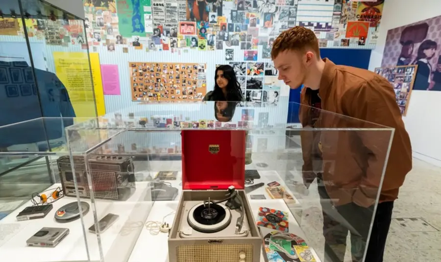 Museum of Youth image showing a person looking at a record player in a display