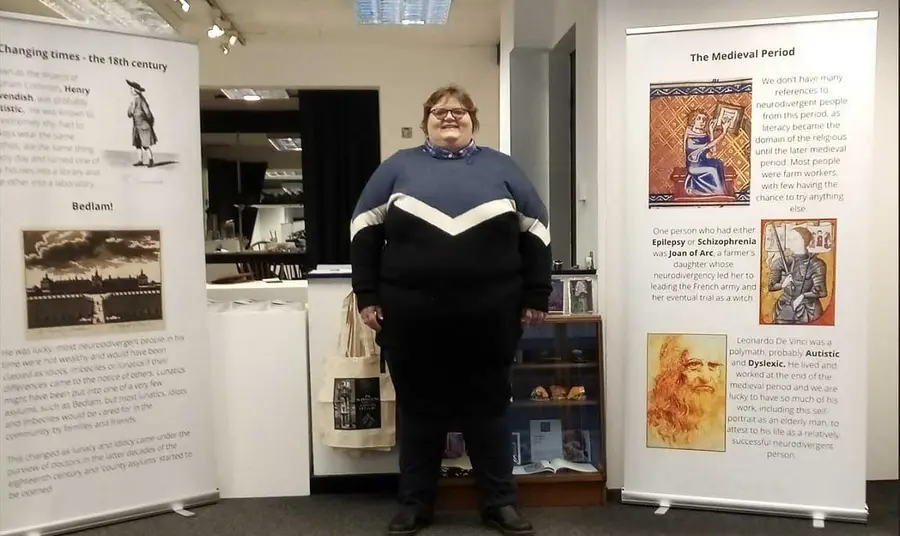 Person standing in front of a display of roller posters