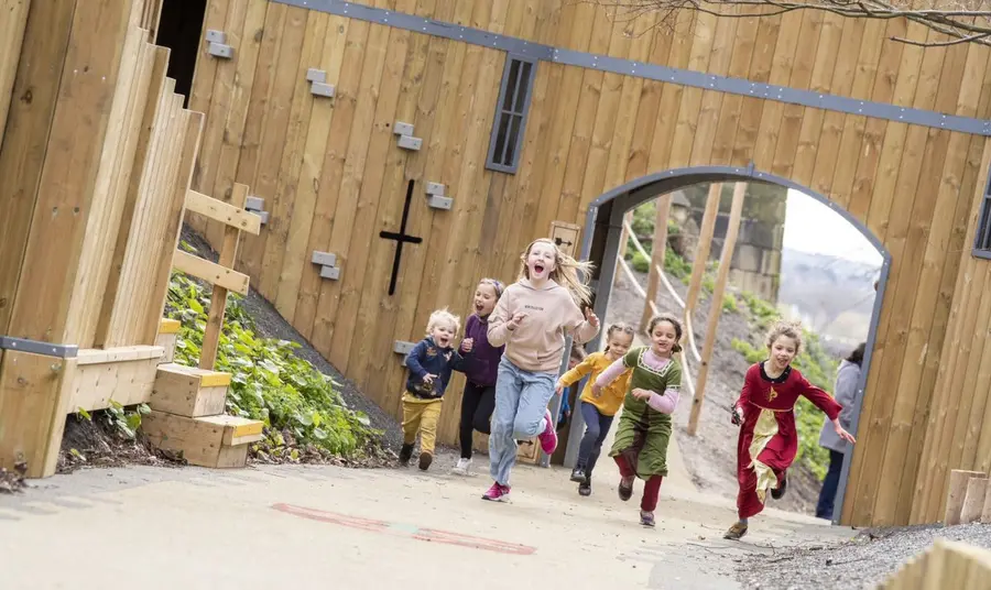 Children running through large arch