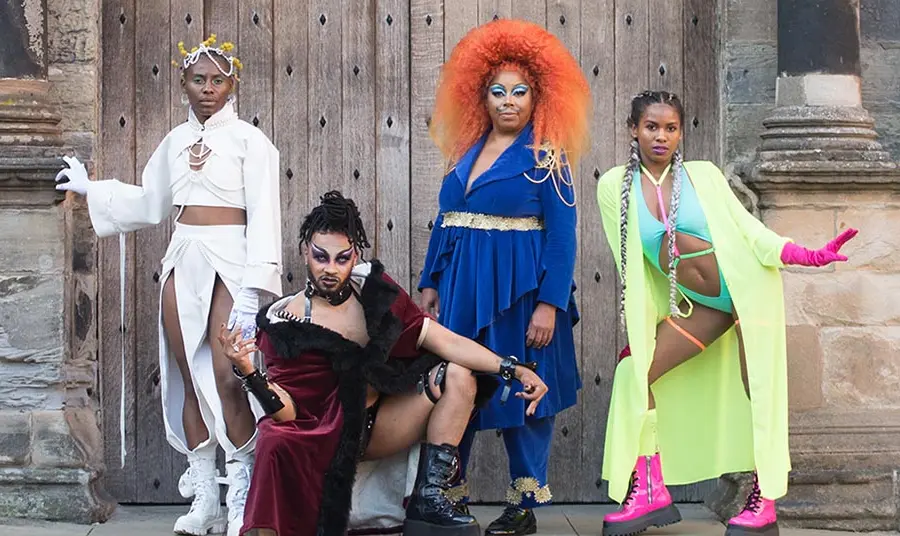 A group of black performers in colourful costumes at Stirling Castle