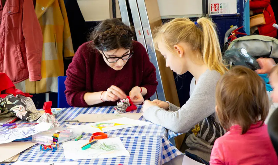 Woman making crafts with children