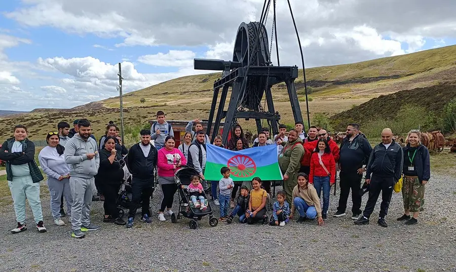Group of people standing outdoors in front of industrial heritage