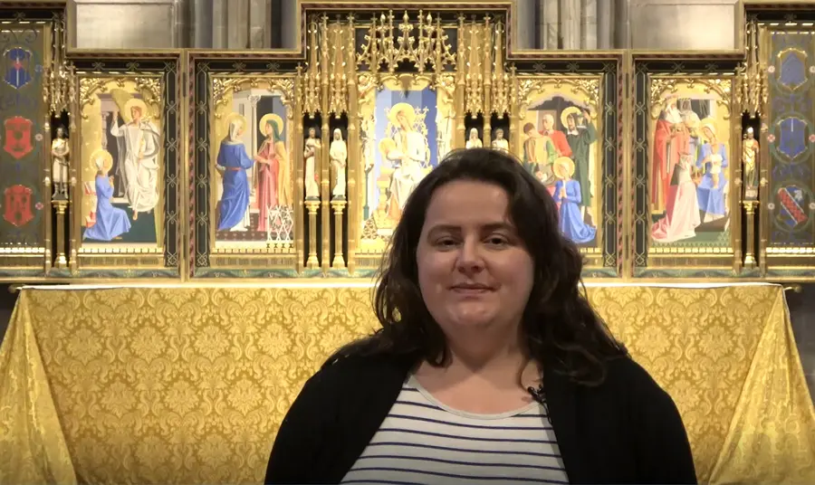 Person stood in Hereford Cathedral. They are talking to the camera.