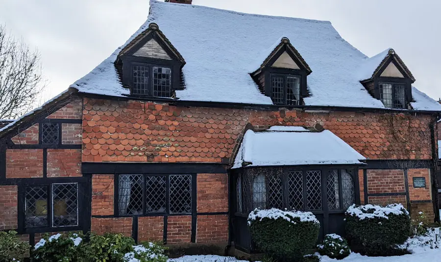 Cranleigh Cottage Hospital A timber-framed building covered in snow