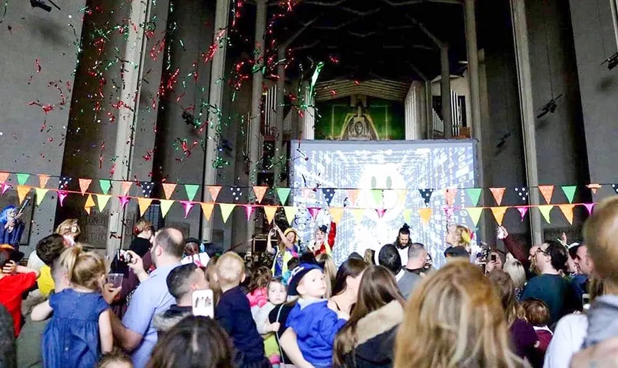 a crowd at a celebration event inside coventry cathedral