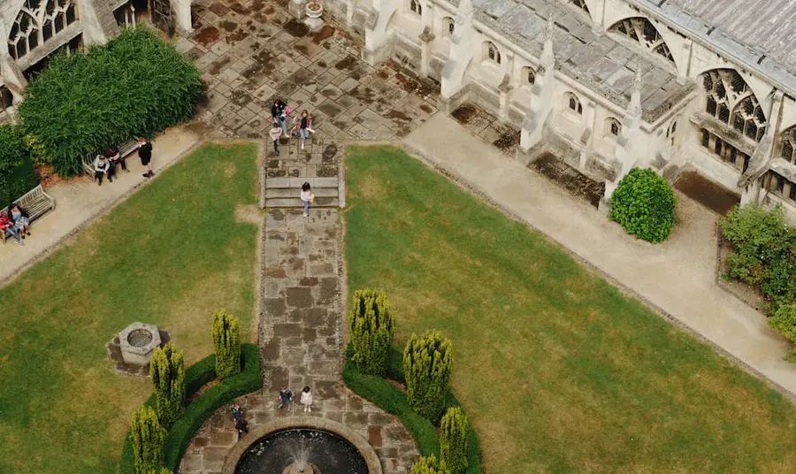 An ariel view of the green space on Gloucester Cathedral grounds with people exploring