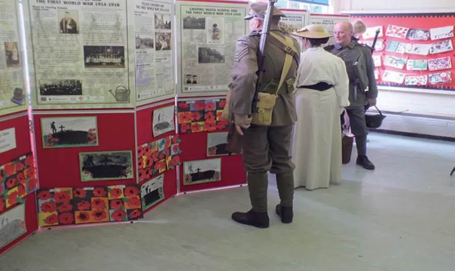 Re-enactors from the WW1 Remembrance Centre, Portsmouth looking at school panels, plus children’s own work