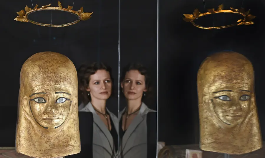 Woman looks at gold objects