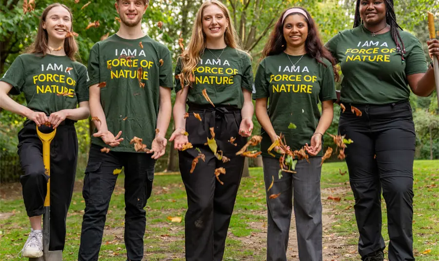 Five young people standing in a row wearing matching T-shirts that say 'I am a force of nature'