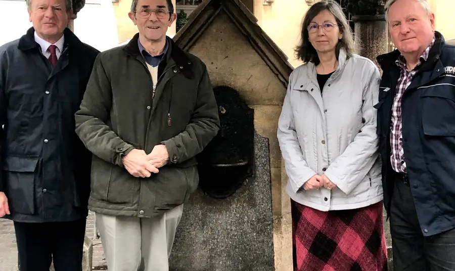 People standing by water fountain
