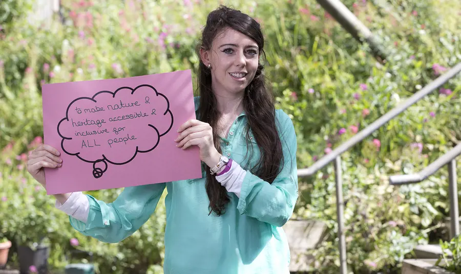 Young woman holding sign