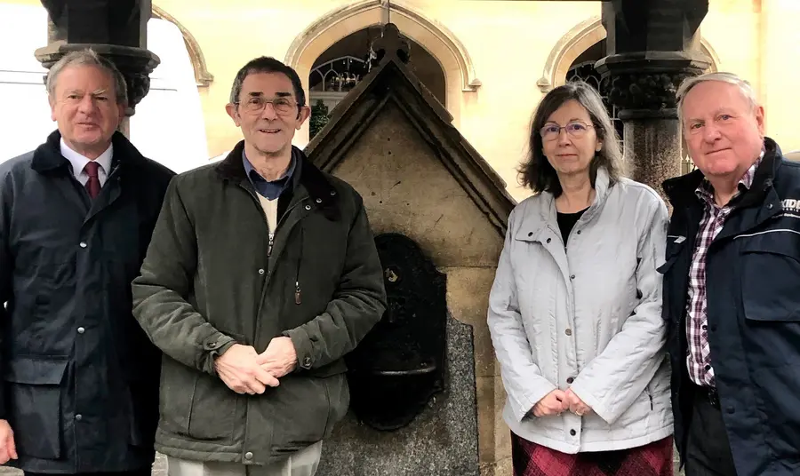 People standing by water fountain