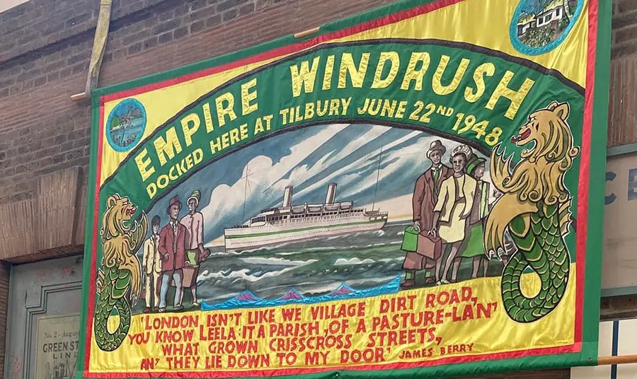 A colourful banner commemorating the landing of the Empire Windrush, saying 'Docked here at Tilbury, June 22nd 1948'