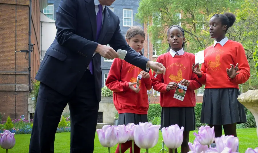 The Prime Minister planting poppy seeds with local school children