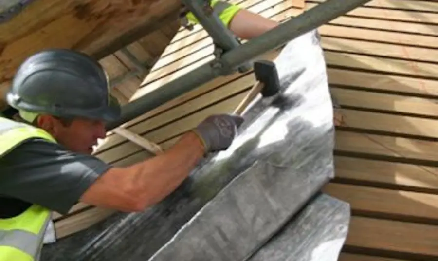 A man repairs the roof at Canterbury Cathedral