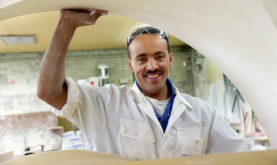 A man holds plaster