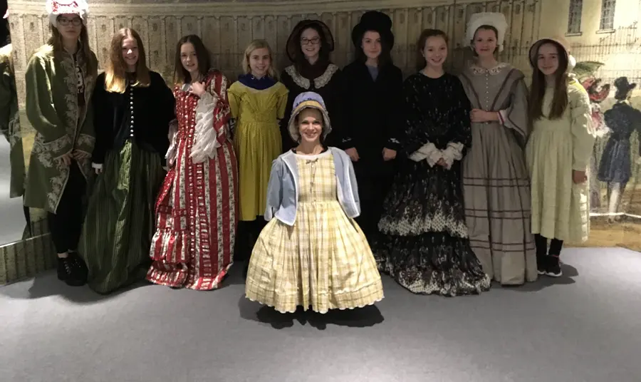 Young people trying on costumes at Bath Costume Museum