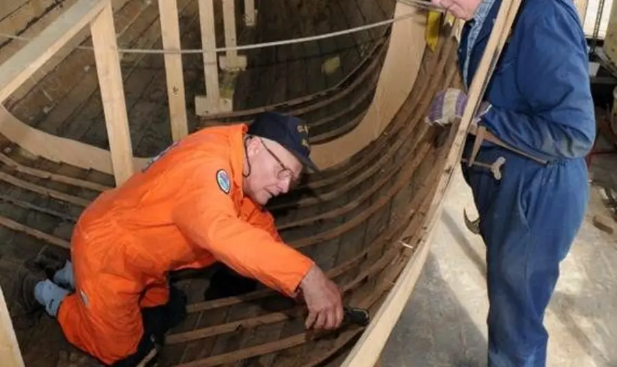 Apprentices learning traditional boat building skills