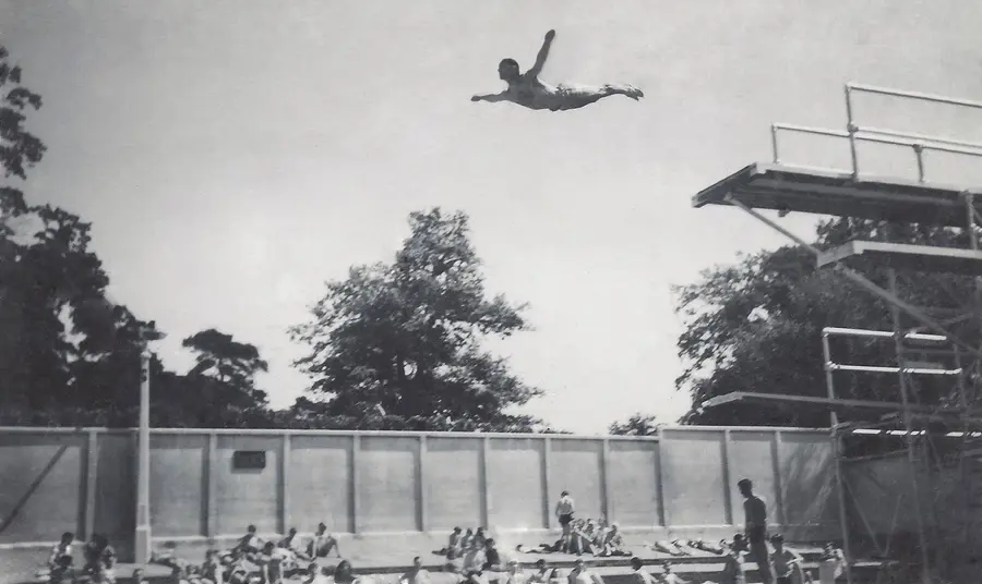 A man dives from the diving board at Broomhill Pool