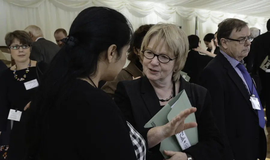 Dame Seona Reid talks to a woman at an event