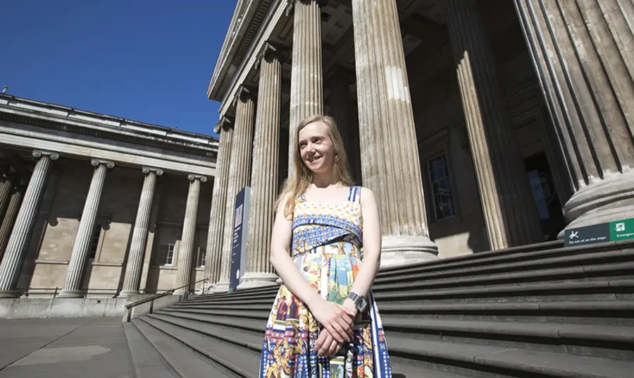 Jessica Starns stands outside the grand British Museum building, smiling