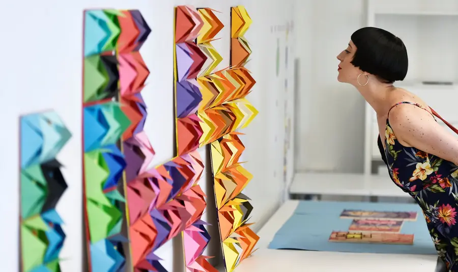 A woman looks at a colourful exhibit 