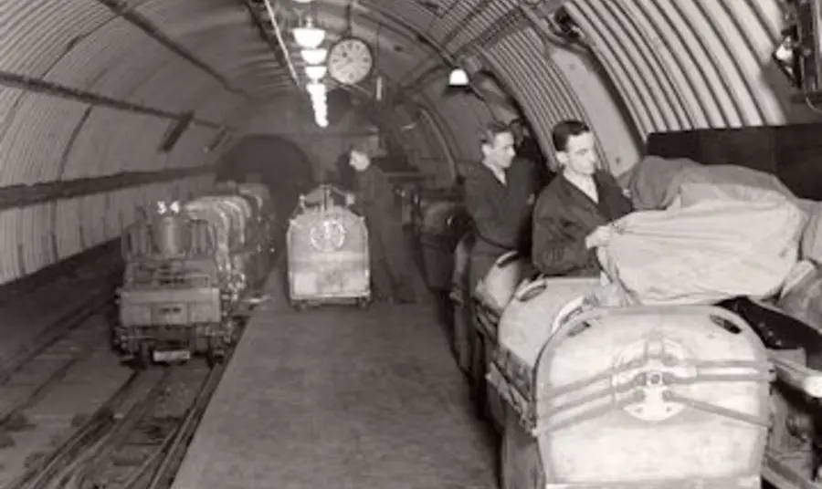 People sort post on the subterranean Mail Rail train