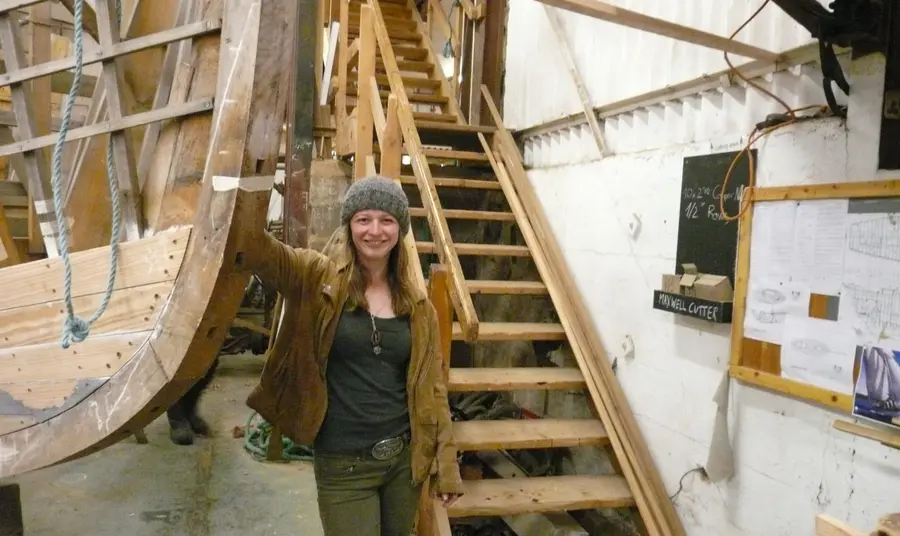 Menyw yn sefyll ar long hanesyddol