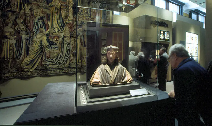 Man looks at statue in museum 