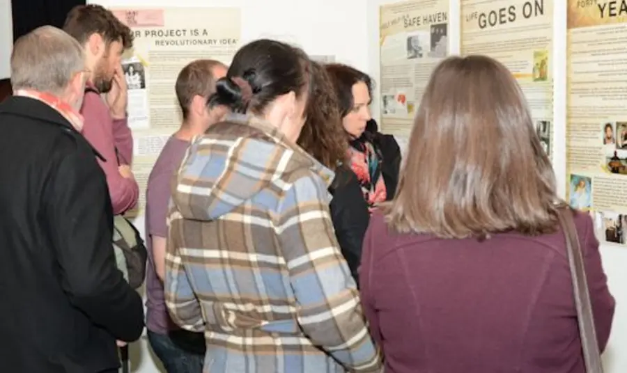 People visiting a Children of the Croft pop-up exhibition